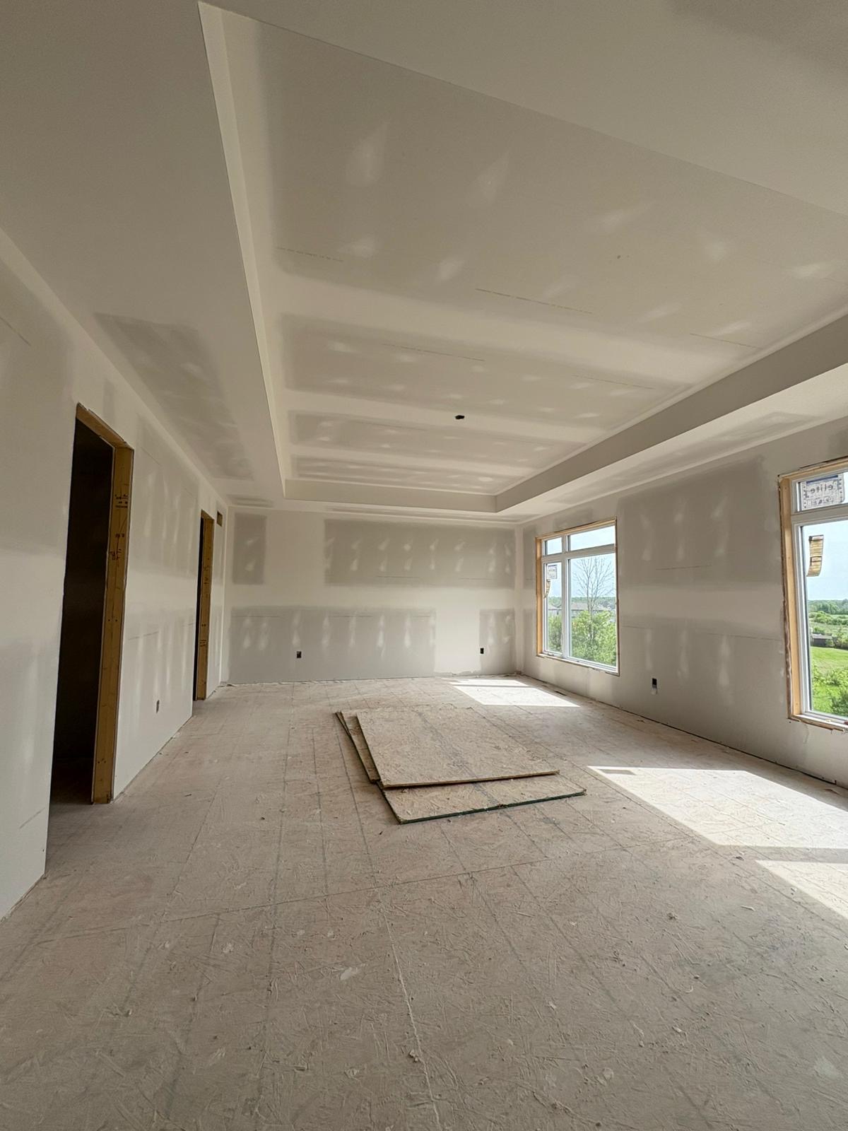 Bright living space with finished tray ceiling