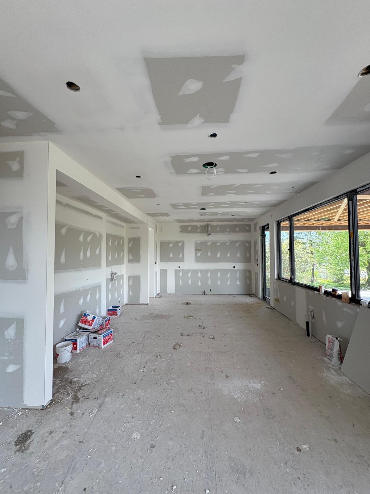 Long open space with taped walls and ceiling