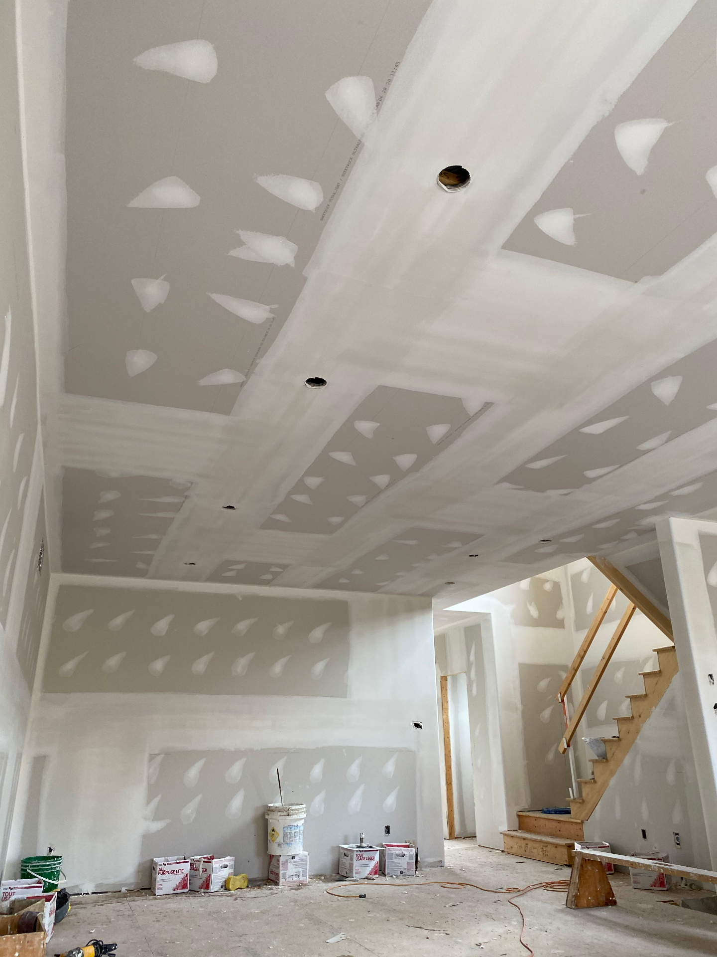 High vaulted ceiling with fresh drywall and taping